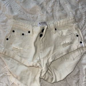 Cream One Teaspoon high-rise distressed denim shorts.